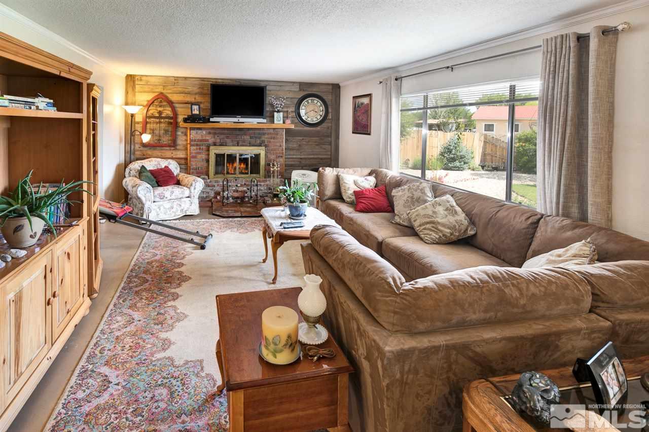 1096 Rice Road Fallon, NV 89406 - Photo 5 of 24 a living room with furniture a flat screen tv and a fireplace