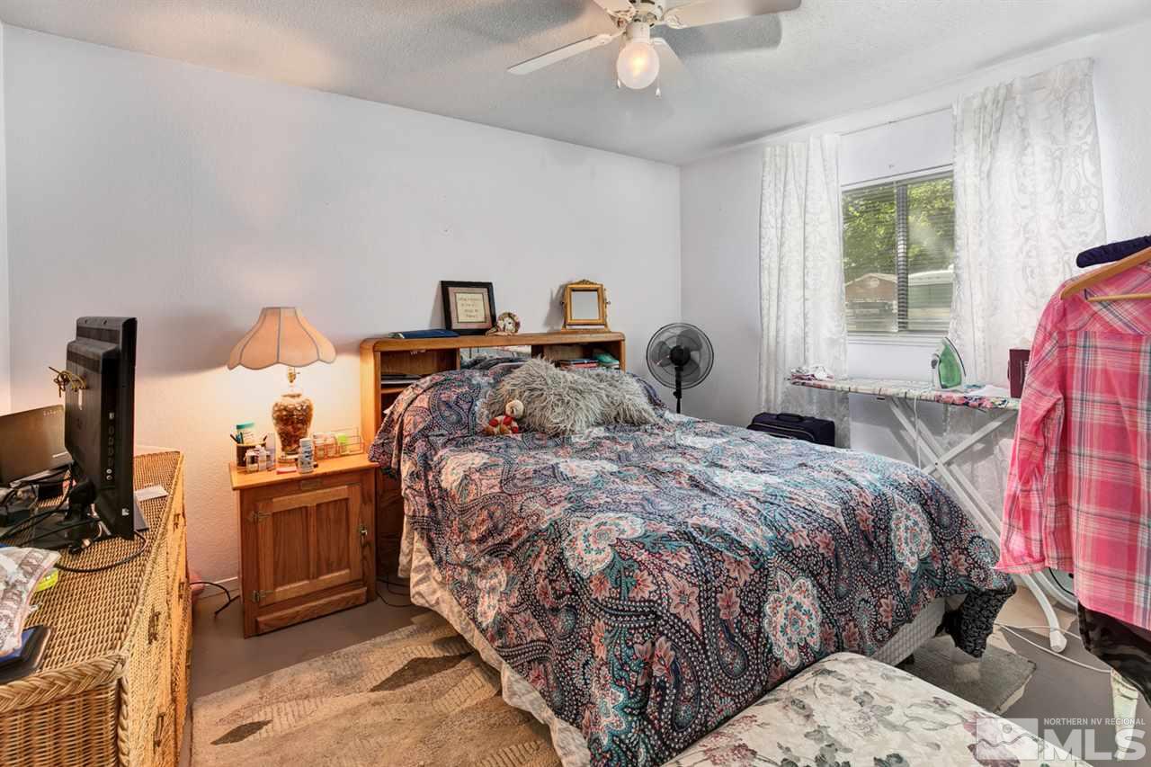 1096 Rice Road Fallon, NV 89406 - Photo 10 of 24 a bedroom with a bed and wooden floor
