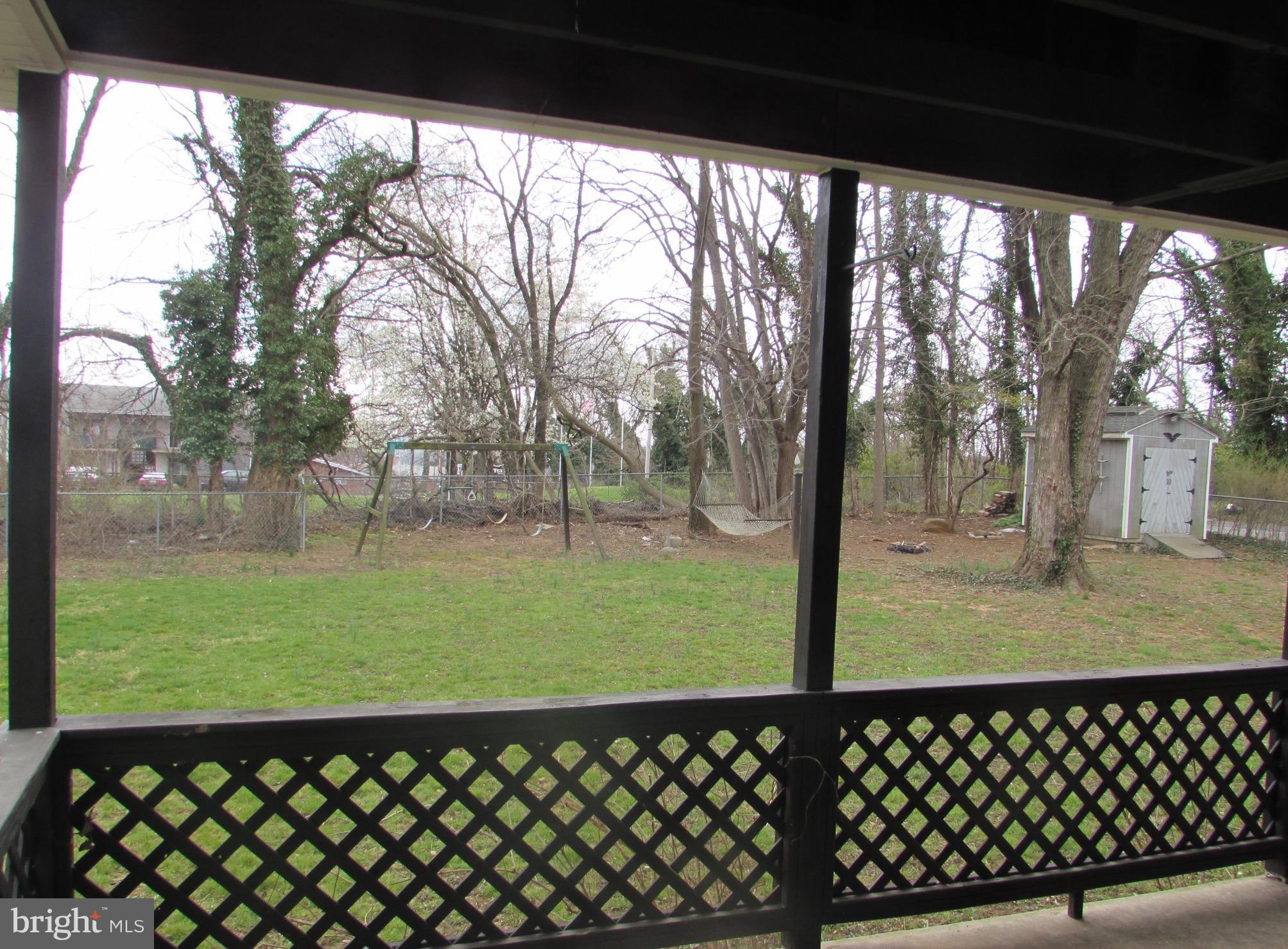 305 Nottingham Road Baltimore, MD 21229 - Photo 22 of 25 Covered deck overlooks large fenced yard with shed