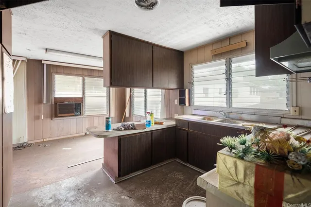 a kitchen with a large window and cabinets