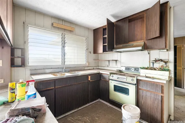 a kitchen with a sink stove and cabinets