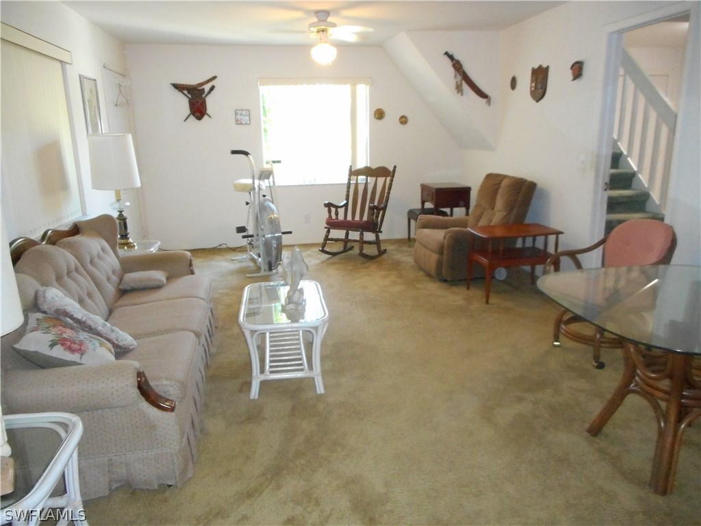 8470 Robin Road Fort Myers, FL 33967 - Photo 13 of 24 a living room with furniture and a chandelier