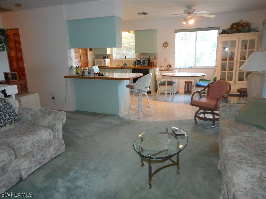 8470 Robin Road Fort Myers, FL 33967 - Photo 9 of 24 a living room with furniture and a kitchen