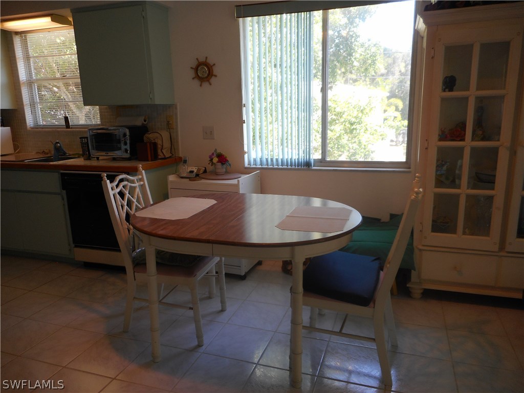 8470 Robin Road Fort Myers, FL 33967 - Photo 10 of 24 a view of a dining room with furniture window and wooden floor