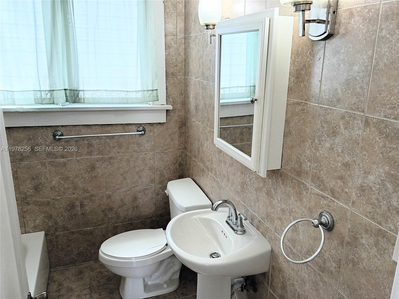 2346 Southwest 20th Street Miami, FL 33145 - Photo 11 of 14 a bathroom with a sink toilet and shower
