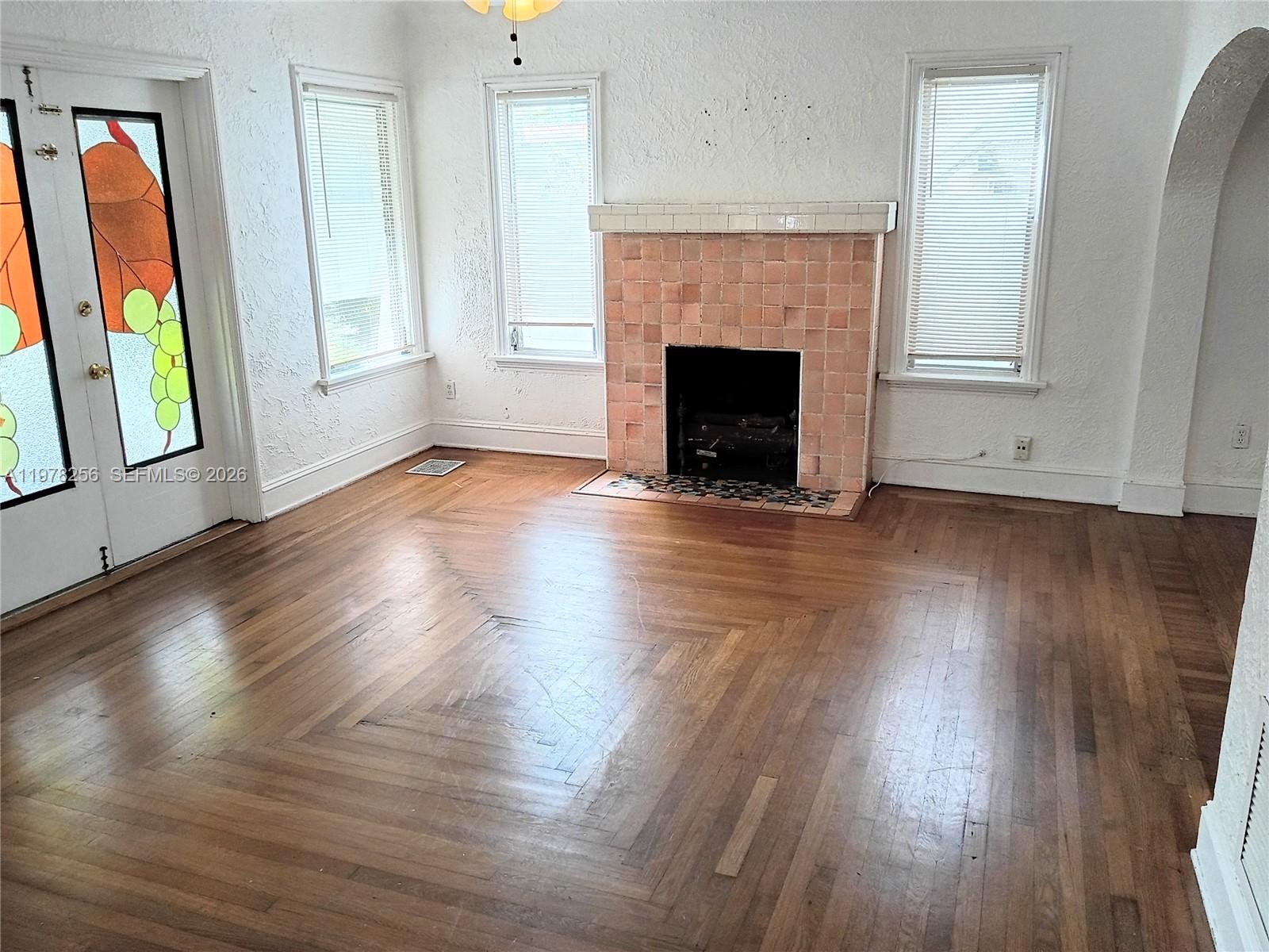 2346 Southwest 20th Street Miami, FL 33145 - Photo 3 of 14 an empty room with wooden floor and fireplace