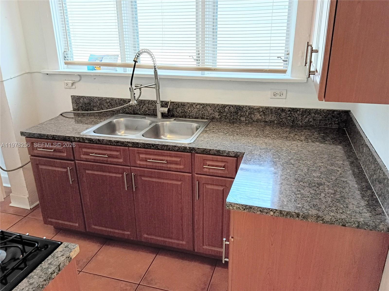 2346 Southwest 20th Street Miami, FL 33145 - Photo 8 of 14 a kitchen with granite countertop a sink and a stove