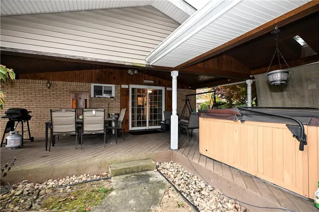 a view of a patio with table and chairs with wooden floor and fence