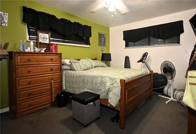 a bedroom with a bed and a flat tv screen