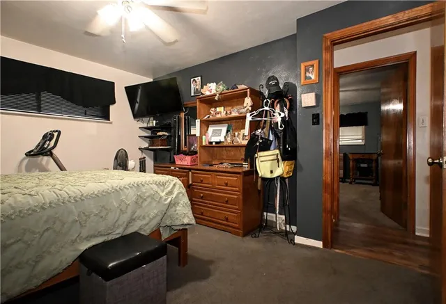 a bedroom with a bed and a flat tv screen