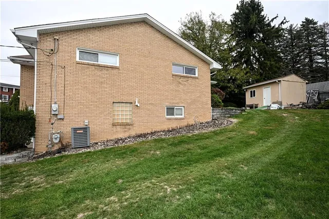a view of an house with backyard space and garden