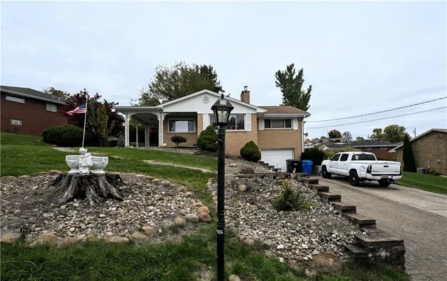 a view of a house with backyard sitting area and garden