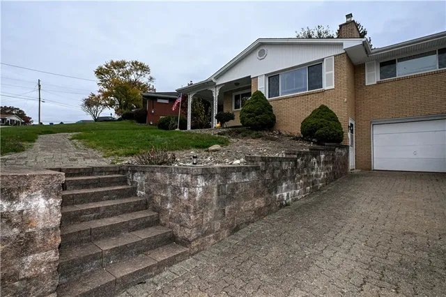 a front view of a house with a garden