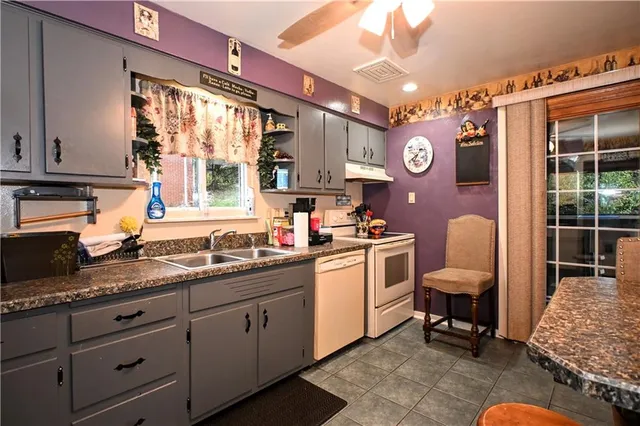 a kitchen with sink cabinets and outdoor view