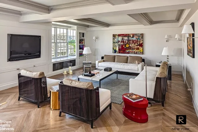 a living room with furniture a flat screen tv and a large window