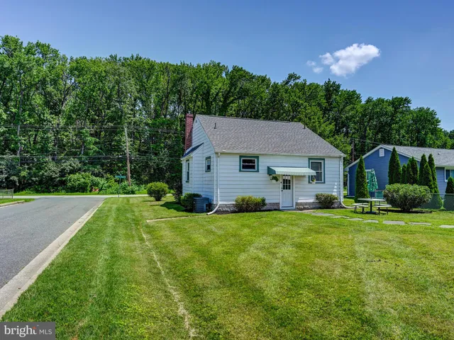 a front view of house with a garden and yard