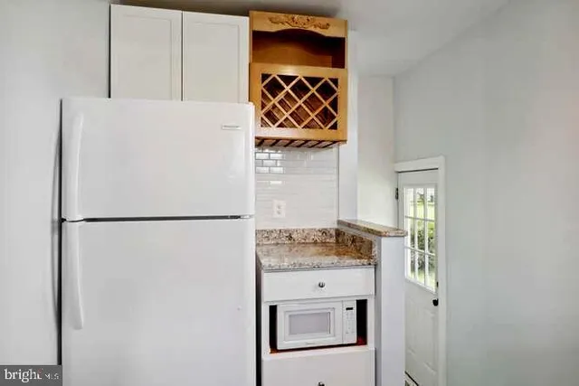 a white refrigerator freezer sitting inside of a kitchen