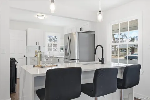 a kitchen with white cabinets stainless steel appliances and sink