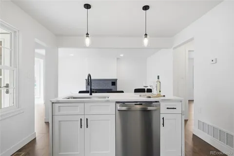 a kitchen with stainless steel appliances a stove a sink and a microwave