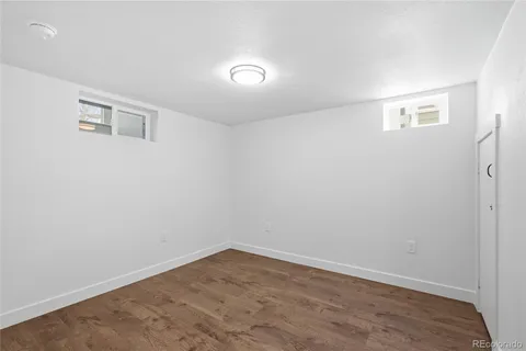 a view of a house with a large tree and a yard