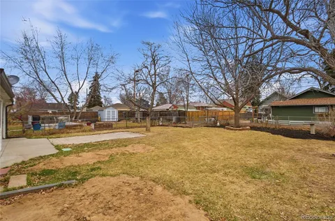 a front view of a house with a large tree and a yard