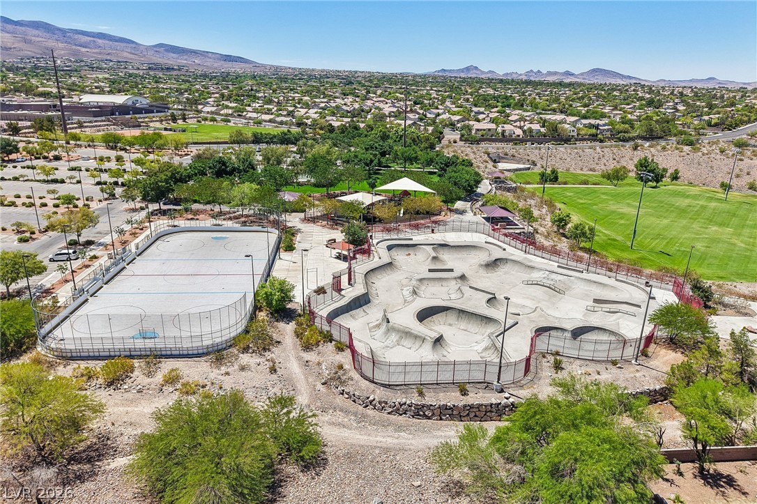 1176 Butternut Ranch Court Henderson, NV 89052 - Photo 55 of 60 An aerial perspective reveals community recreation facilities amidst a verdant landscape and distant homes.