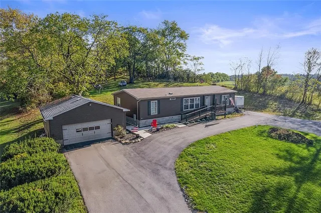 an aerial view of a house with garden space and lake view