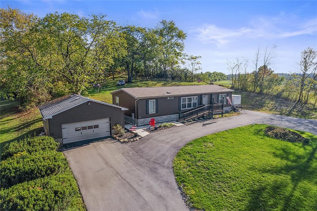 an aerial view of a house with garden space and lake view