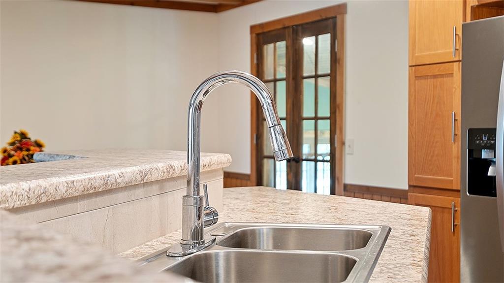 86 Eldersville Road Burgettstown, PA 15021 - Photo 12 of 50 a kitchen with a granite countertop sink and natural light