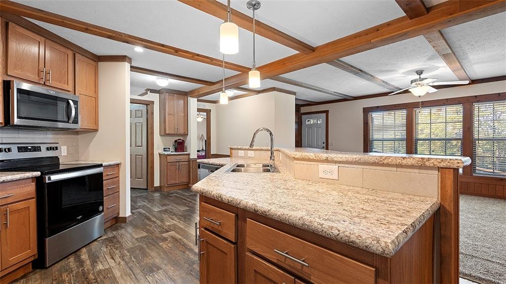 86 Eldersville Road Burgettstown, PA 15021 - Photo 14 of 50 a kitchen with kitchen island granite countertop wooden cabinets and a refrigerator