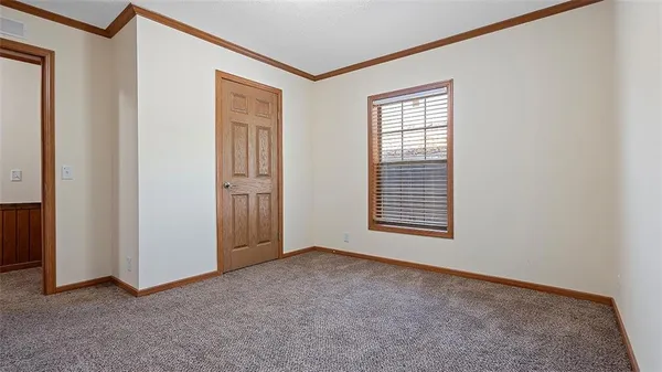 an empty room with closet area