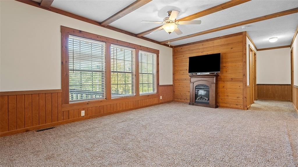 86 Eldersville Road Burgettstown, PA 15021 - Photo 8 of 50 an empty room with windows fireplace and a flat tv screen