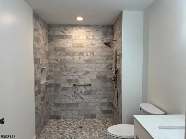 a bathroom with a shower and toilet