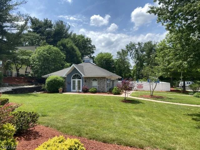 a view of a house with a yard and sitting area