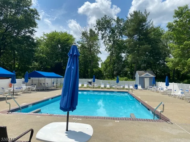 a swimming pool with outdoor seating and yard