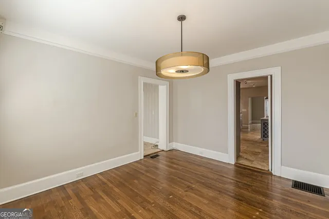 a view of a room with wooden floor gym equipment