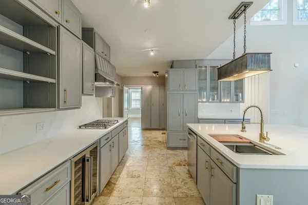 a kitchen with stainless steel appliances cabinets a stove and a window