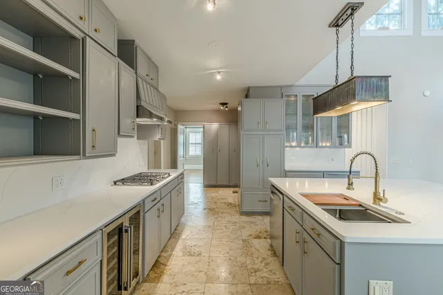 a kitchen with stainless steel appliances cabinets a stove and a window