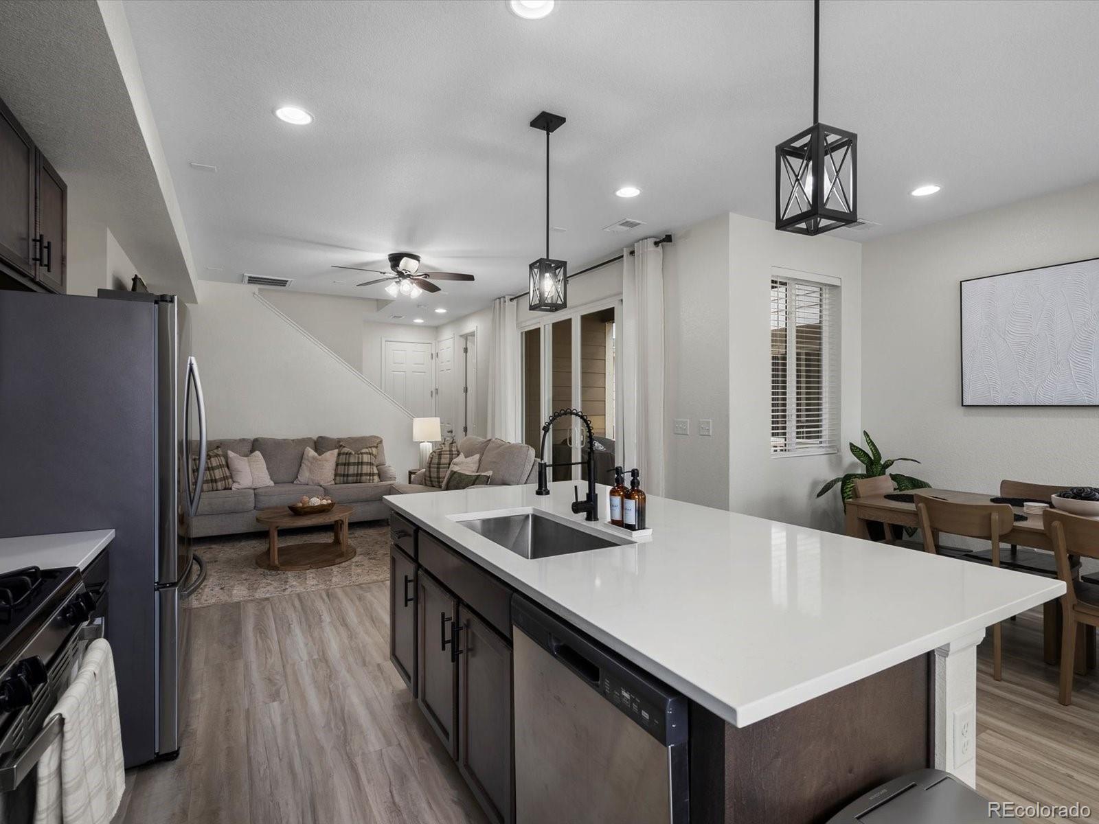 5347 Warrior Street Frederick, CO 80504 - Photo 12 of 48 a kitchen with a counter top space a sink stainless steel appliances and cabinets