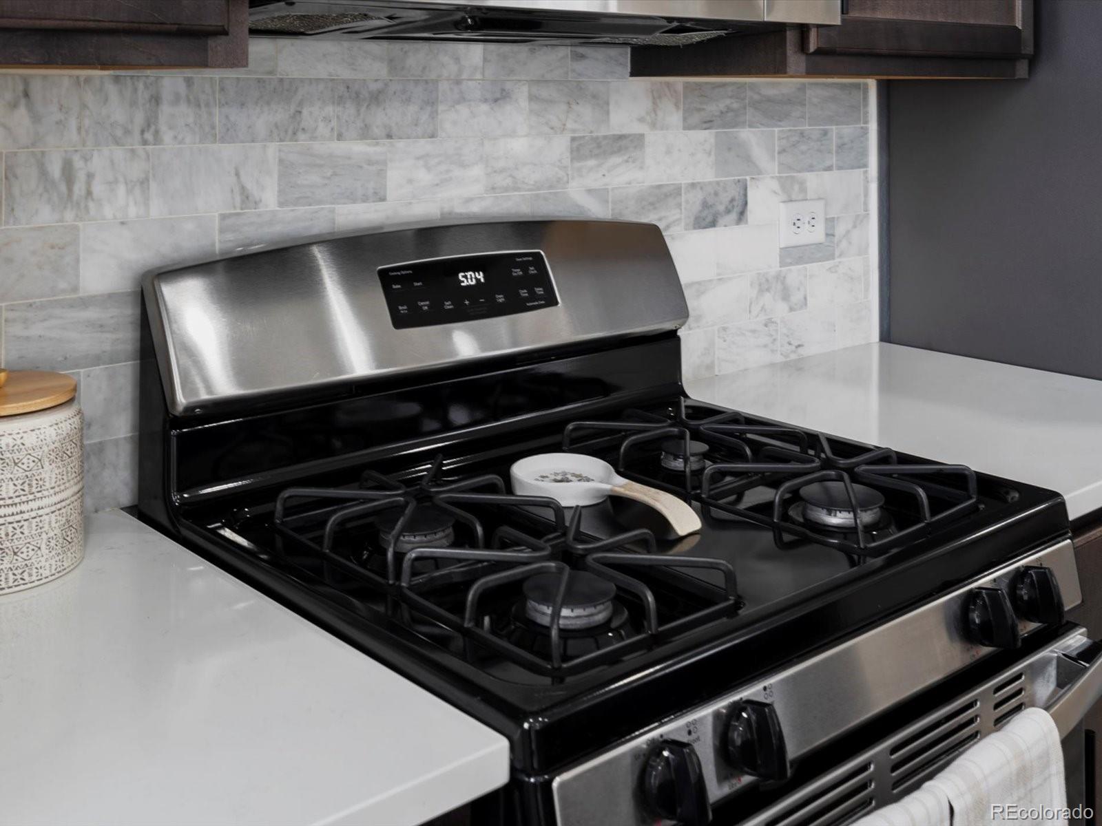 5347 Warrior Street Frederick, CO 80504 - Photo 14 of 48 a stove sitting inside of a kitchen with granite countertop