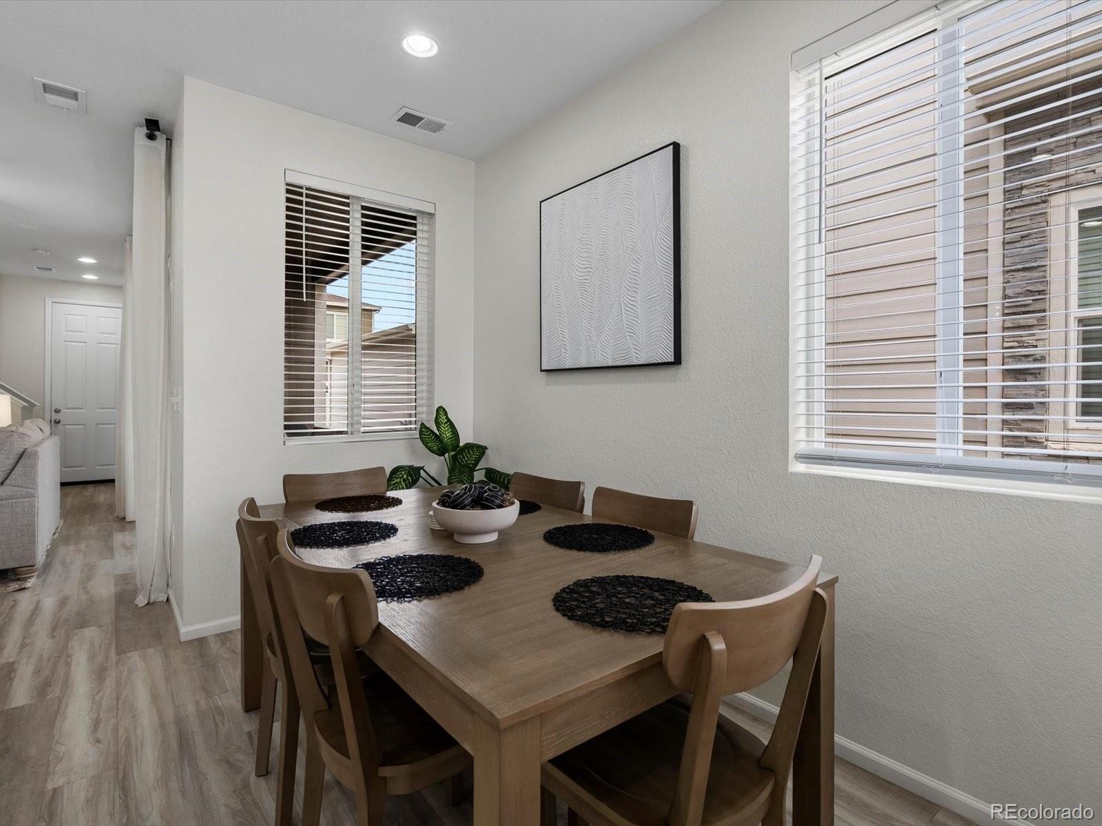 5347 Warrior Street Frederick, CO 80504 - Photo 18 of 48 a view of a dining room with furniture and wooden floor