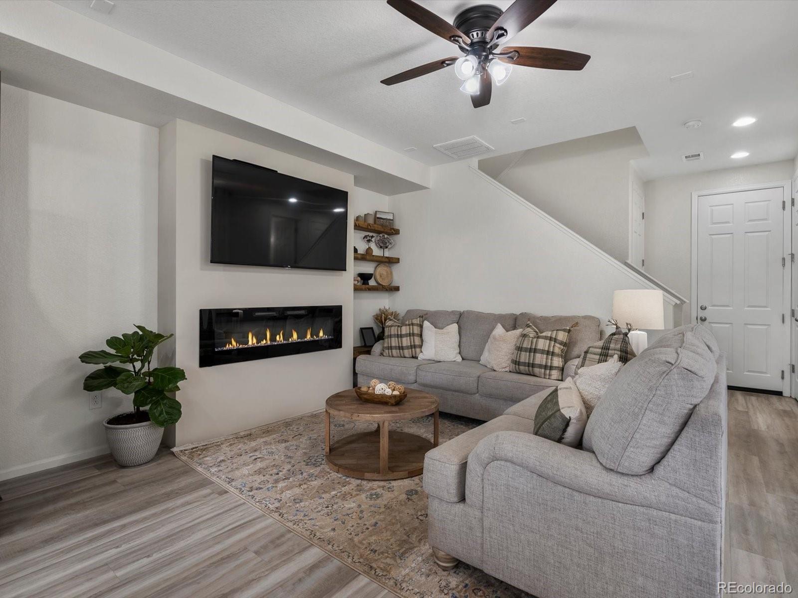 5347 Warrior Street Frederick, CO 80504 - Photo 21 of 48 a living room with furniture and a fireplace