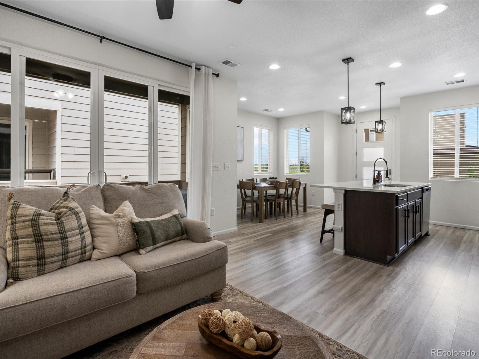 5347 Warrior Street Frederick, CO 80504 - Photo 24 of 48 a living room with furniture window and wooden floor