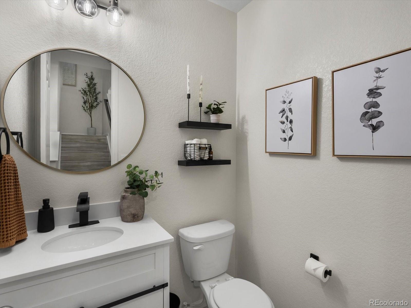 5347 Warrior Street Frederick, CO 80504 - Photo 27 of 48 a bathroom with a toilet a sink and mirror