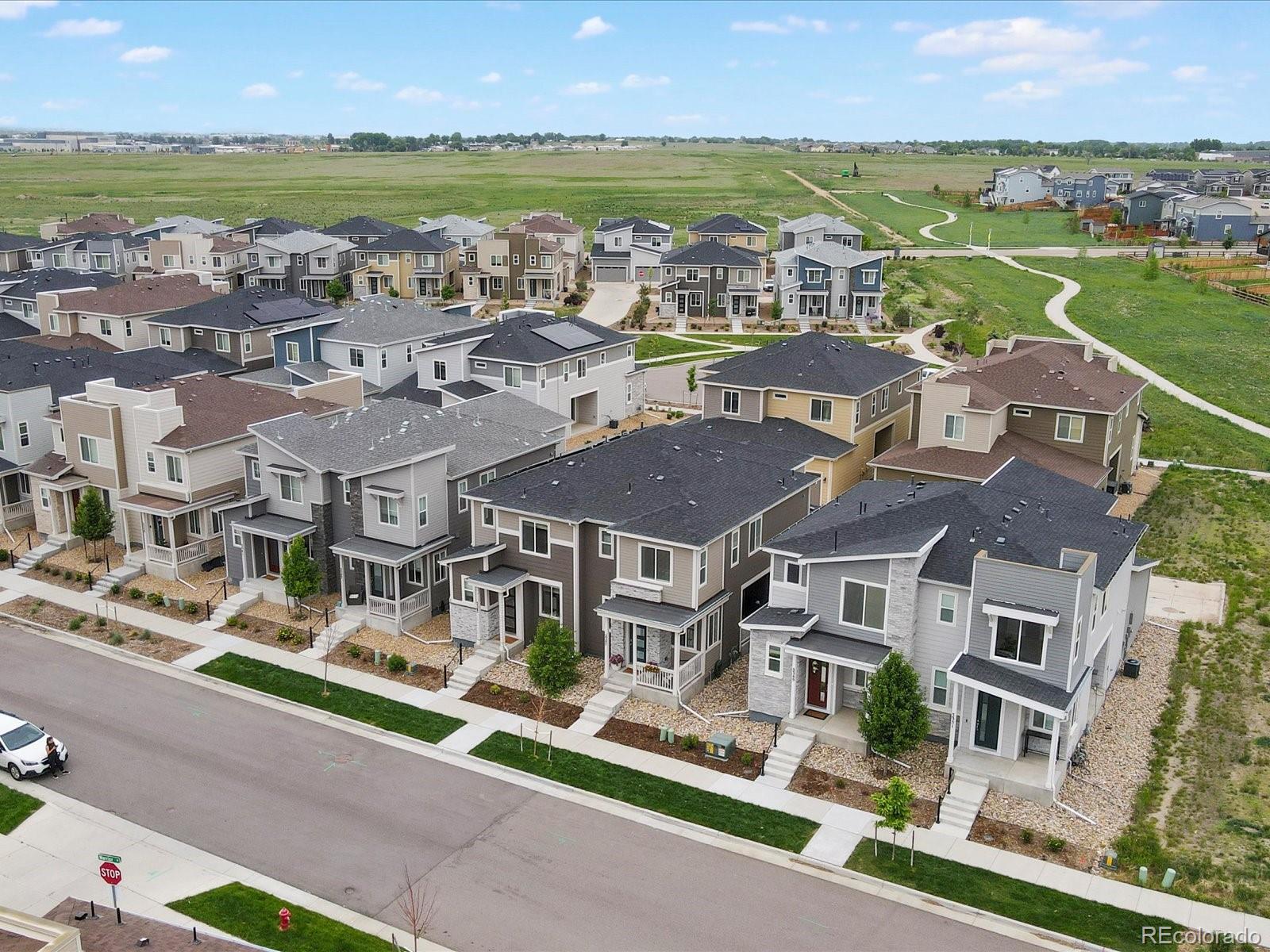 5347 Warrior Street Frederick, CO 80504 - Photo 3 of 48 an aerial view of residential houses with outdoor space and lake view