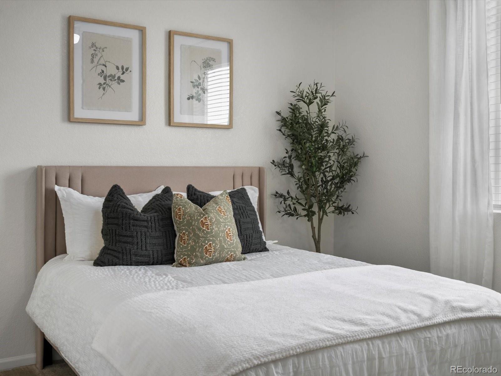 5347 Warrior Street Frederick, CO 80504 - Photo 31 of 48 a bed sitting in a bedroom next to a window and a potted plant