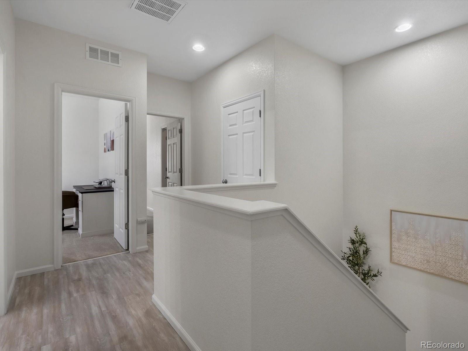 5347 Warrior Street Frederick, CO 80504 - Photo 33 of 48 a view of hallway with wooden floor