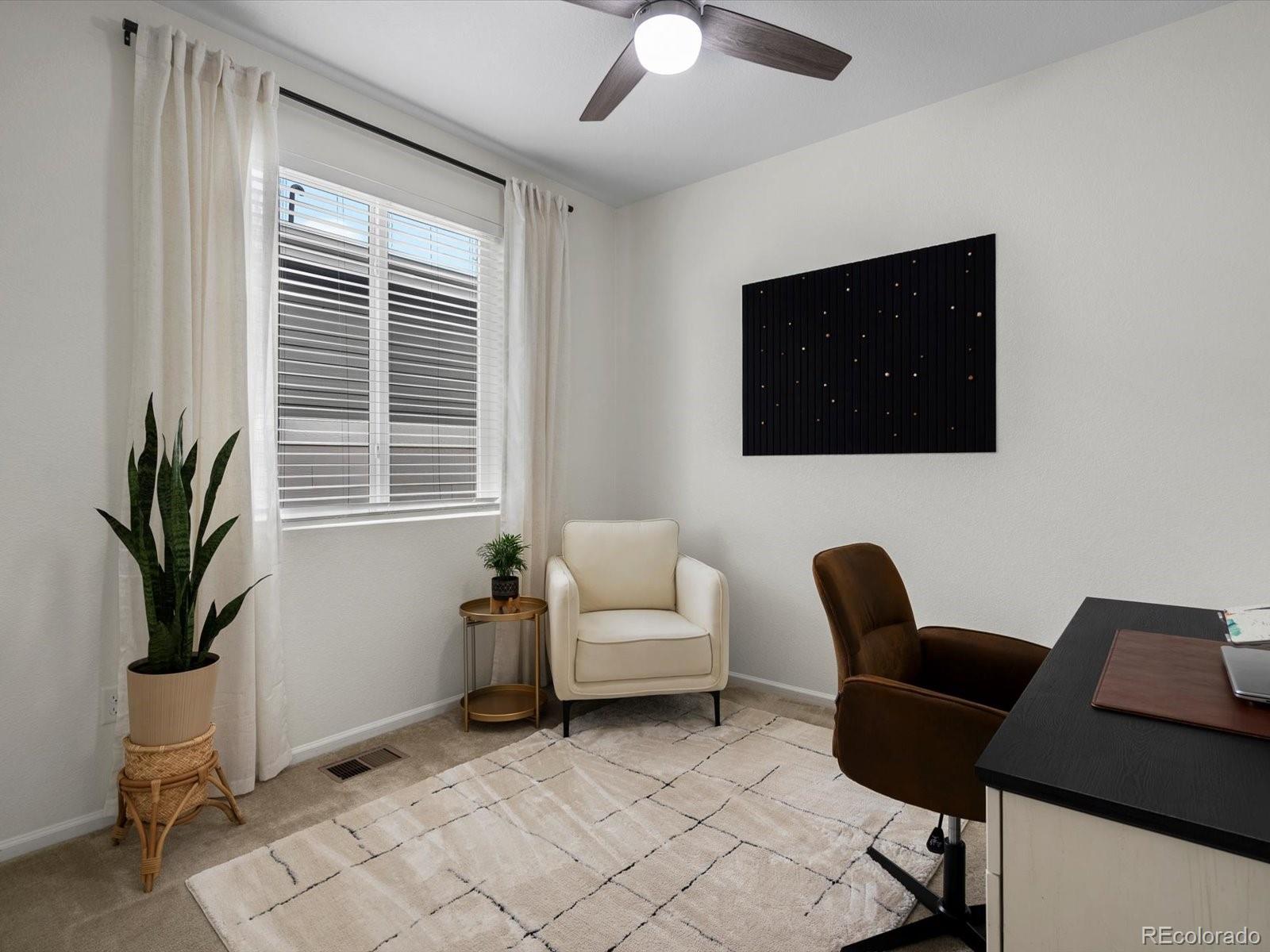 5347 Warrior Street Frederick, CO 80504 - Photo 35 of 48 a living room with furniture and a flat screen tv