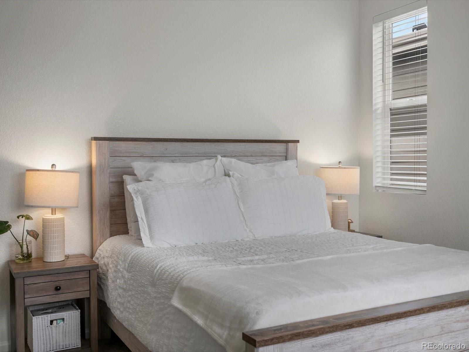 5347 Warrior Street Frederick, CO 80504 - Photo 40 of 48 a bedroom with a bed and a night stand