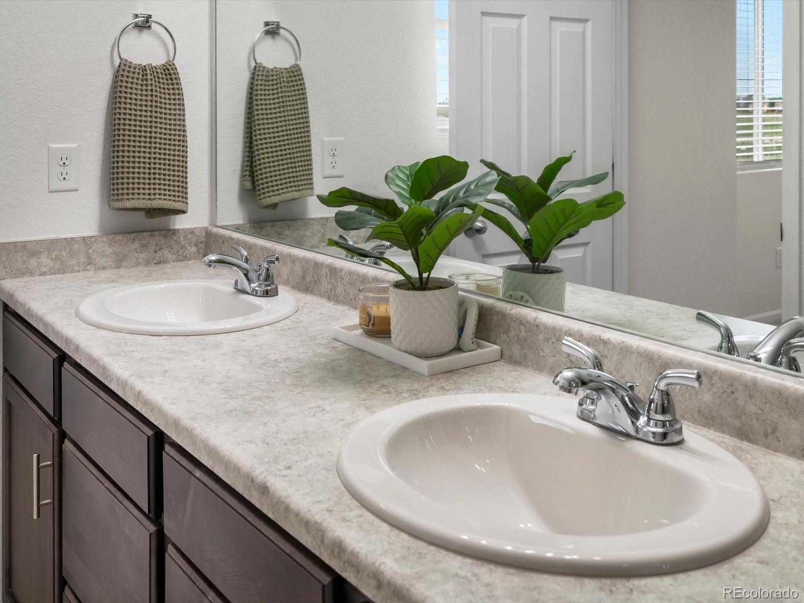 5347 Warrior Street Frederick, CO 80504 - Photo 43 of 48 a bathroom with sinks and a mirror